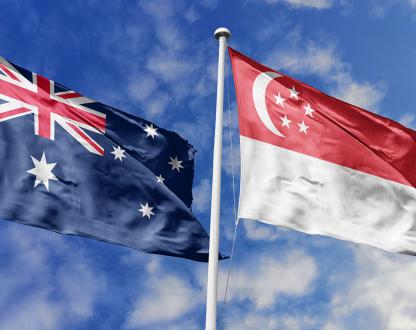 Australia and Singapore flags flying against the sky