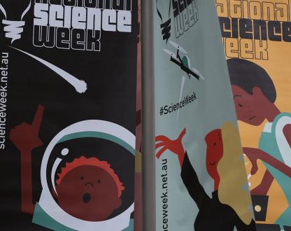 Three National Science Week Questacon flags showing 3 of their science activities cartoon characters.