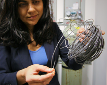 Professor Veena Sahajwalla holding electronic waste